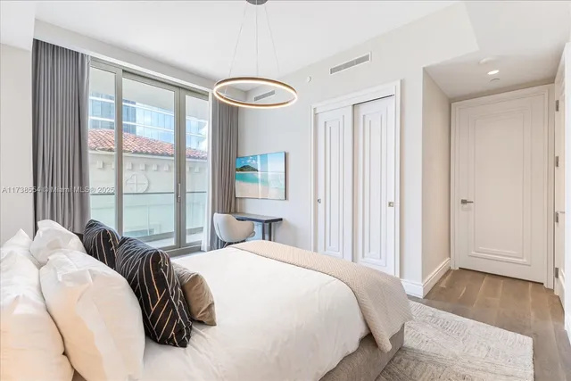 a bedroom with a bed and a large window