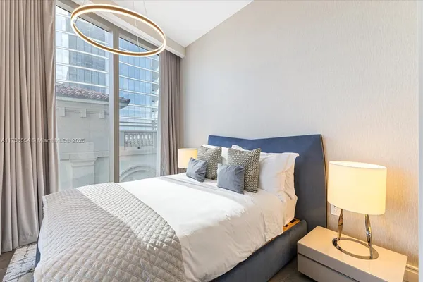 a bedroom with a bed and a lamp