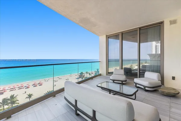 a living room with furniture and floor to ceiling window