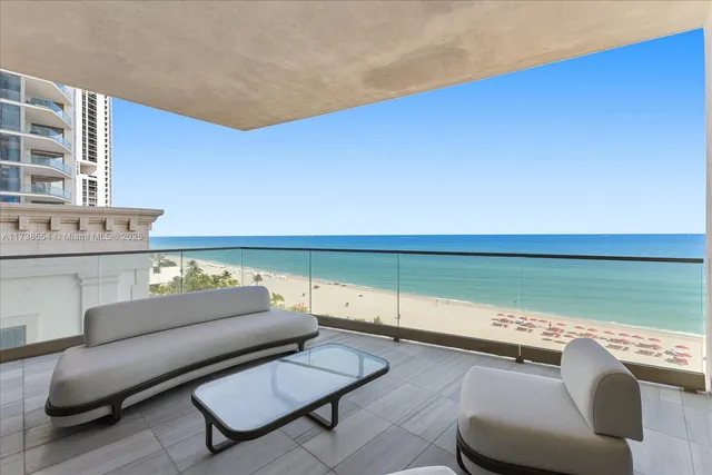 a living room with furniture and a floor to ceiling window