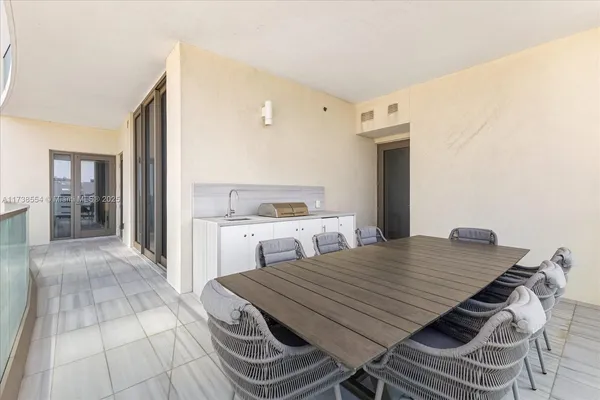 a view of a kitchen with furniture and wooden floor