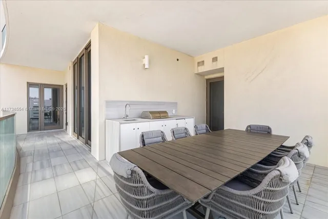 a view of a kitchen with furniture and wooden floor