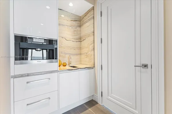 a view of walk in closet with empty room