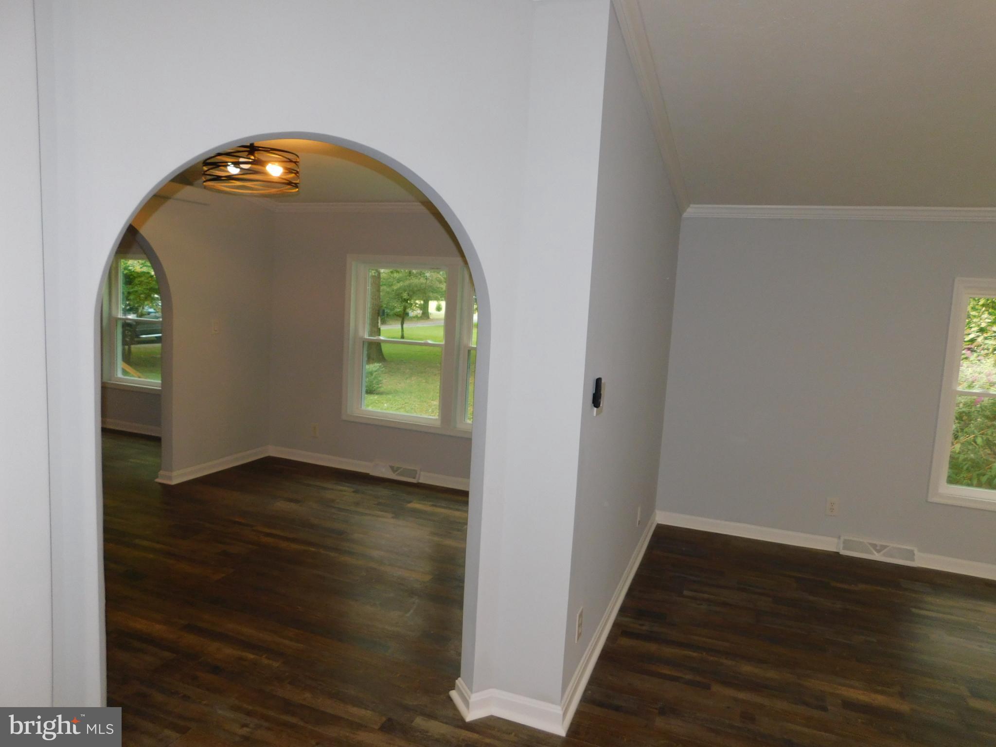 2608 Hunting Quarter Road Houston, DE 19954 - Photo 14 of 58 an empty room with wooden floor mirror and windows