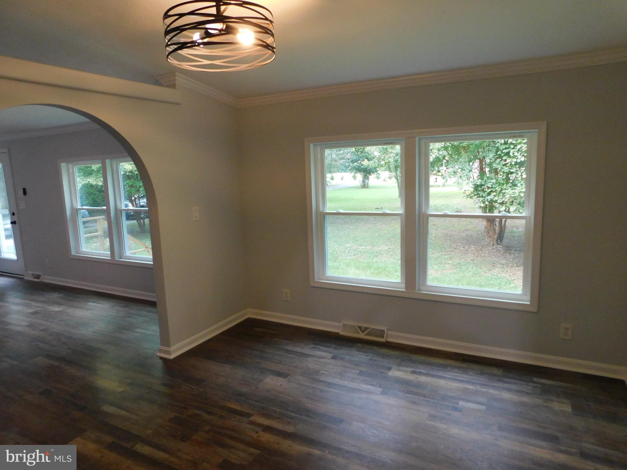 2608 Hunting Quarter Road Houston, DE 19954 - Photo 18 of 58 an empty room with wooden floor fan and windows