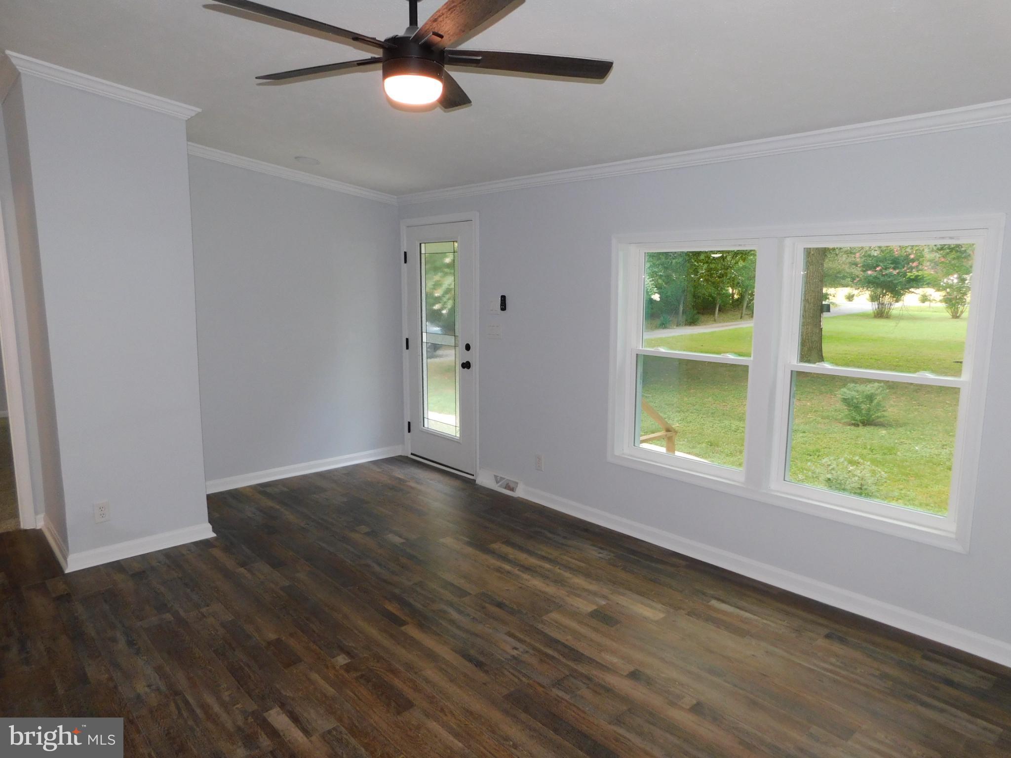 2608 Hunting Quarter Road Houston, DE 19954 - Photo 19 of 58 a view of an empty room with a window and wooden floor