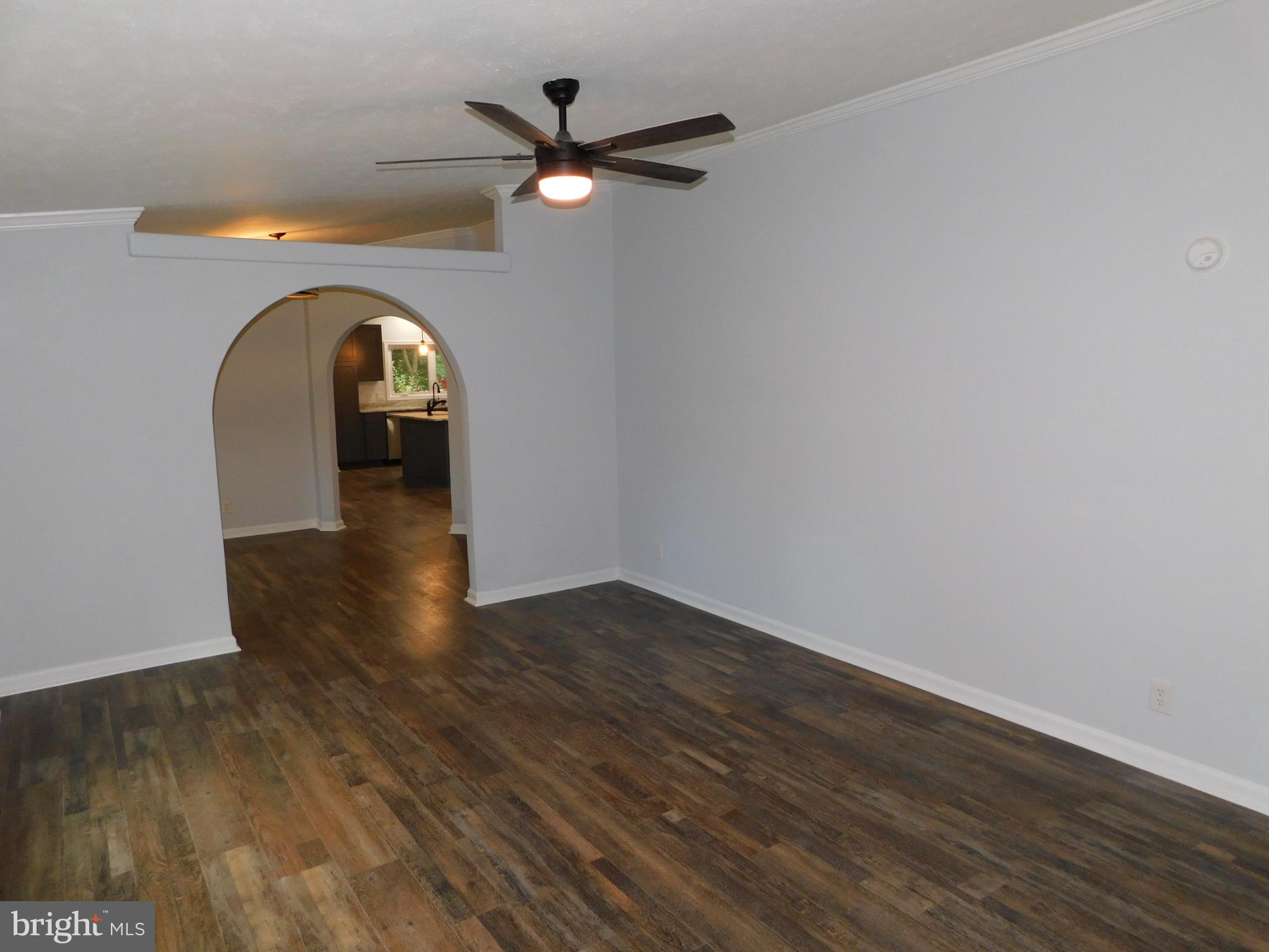 2608 Hunting Quarter Road Houston, DE 19954 - Photo 21 of 58 a view of a livingroom with wooden floor and a ceiling fan