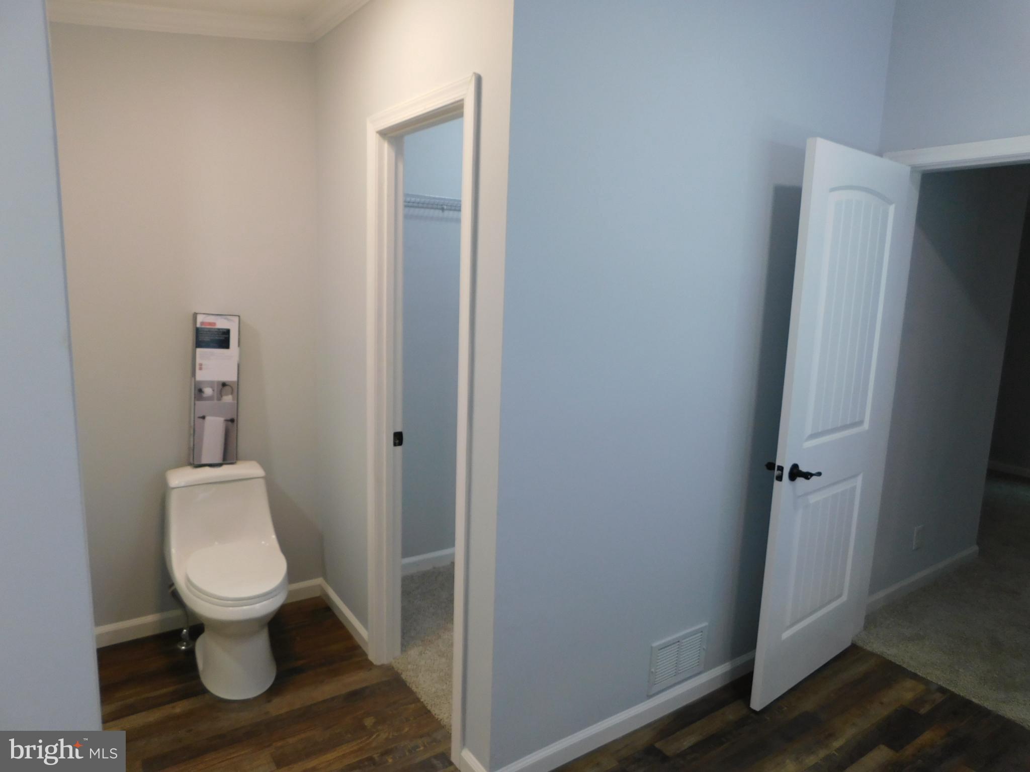 2608 Hunting Quarter Road Houston, DE 19954 - Photo 33 of 58 a white toilet sitting next to a bathroom sink