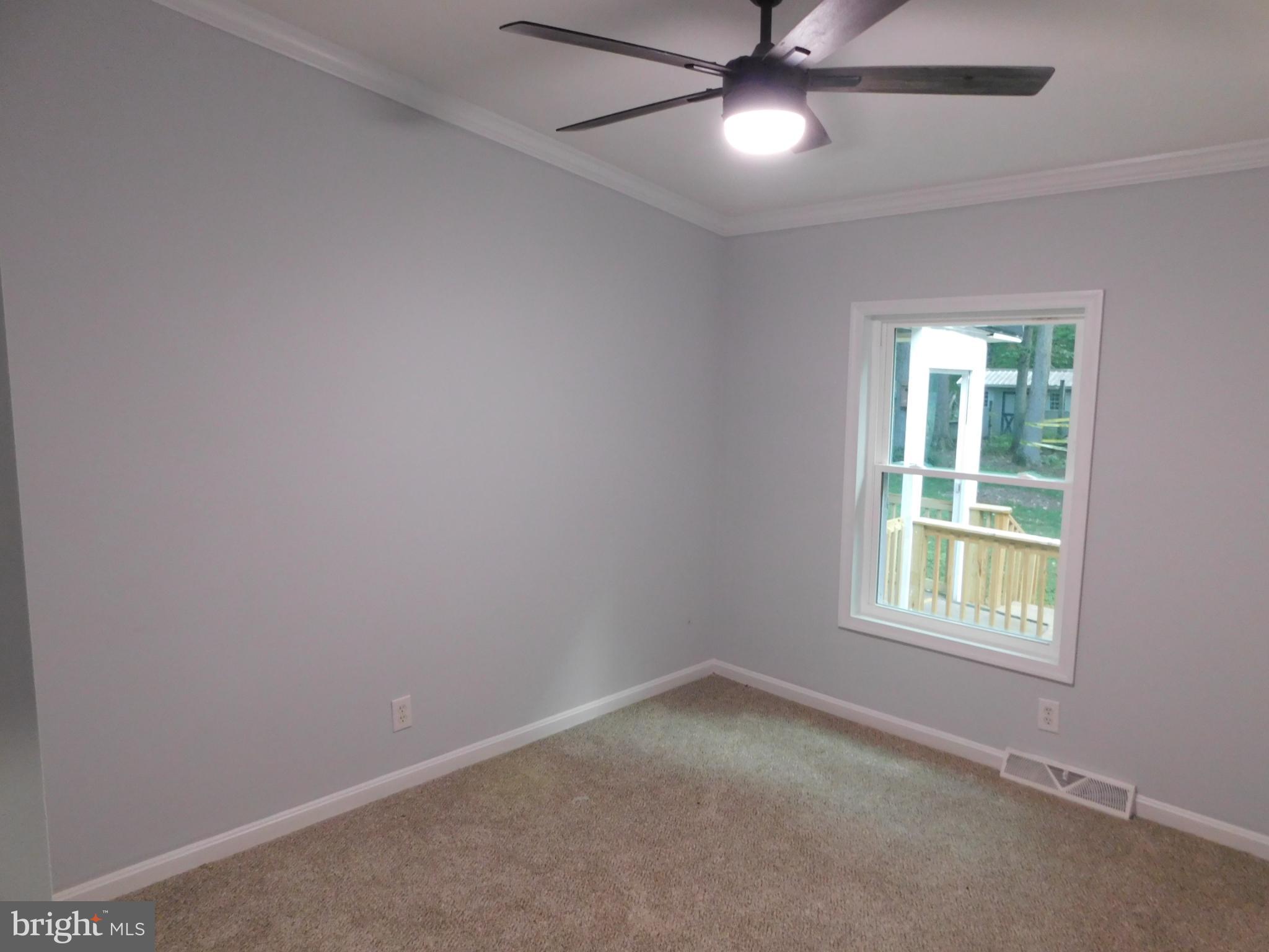 2608 Hunting Quarter Road Houston, DE 19954 - Photo 39 of 58 an empty room with a window and a fan