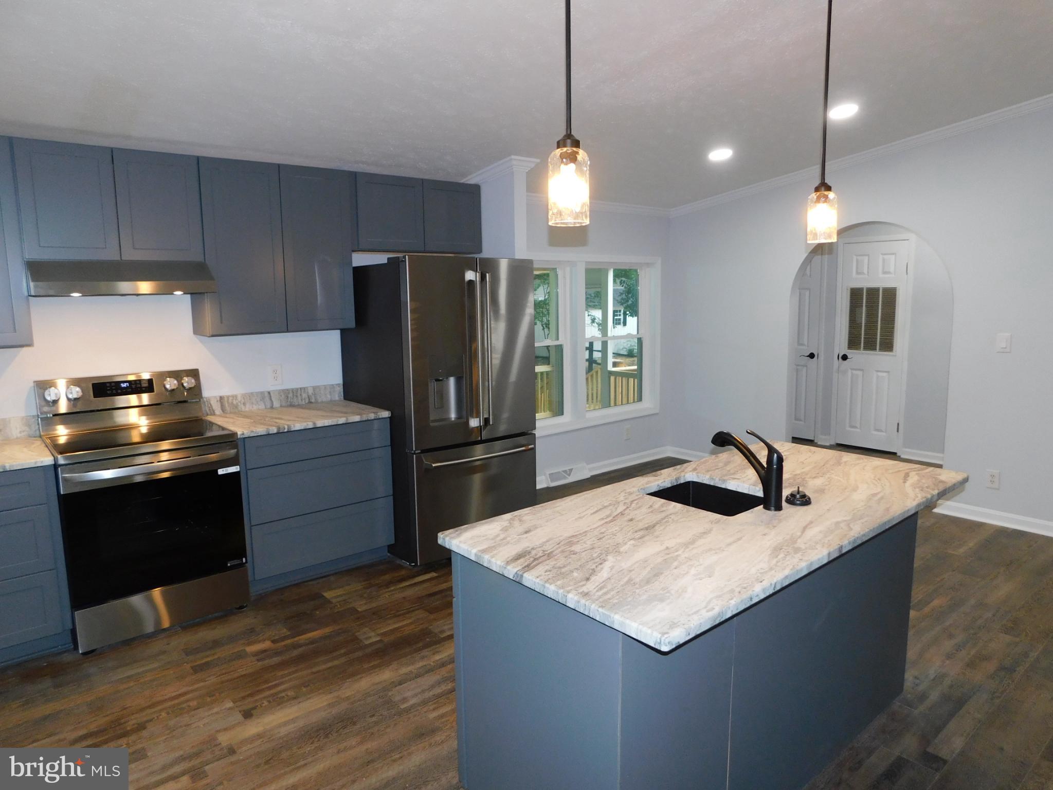 2608 Hunting Quarter Road Houston, DE 19954 - Photo 4 of 58 a kitchen with stainless steel appliances granite countertop a sink a stove and a refrigerator