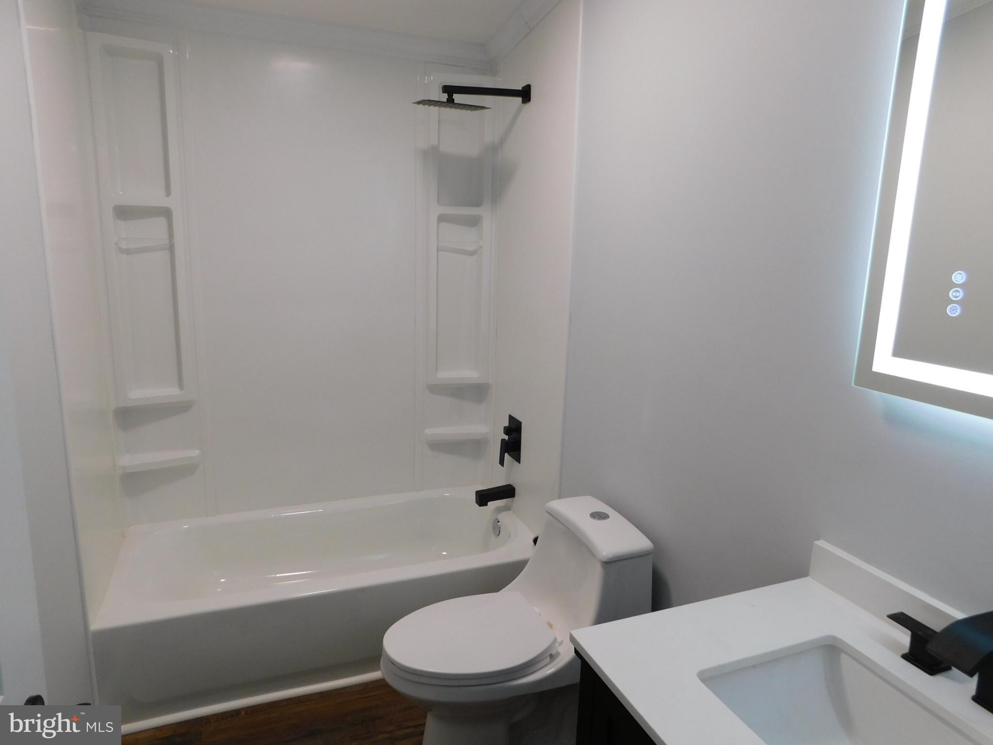 2608 Hunting Quarter Road Houston, DE 19954 - Photo 44 of 58 a white toilet and tub next to a window