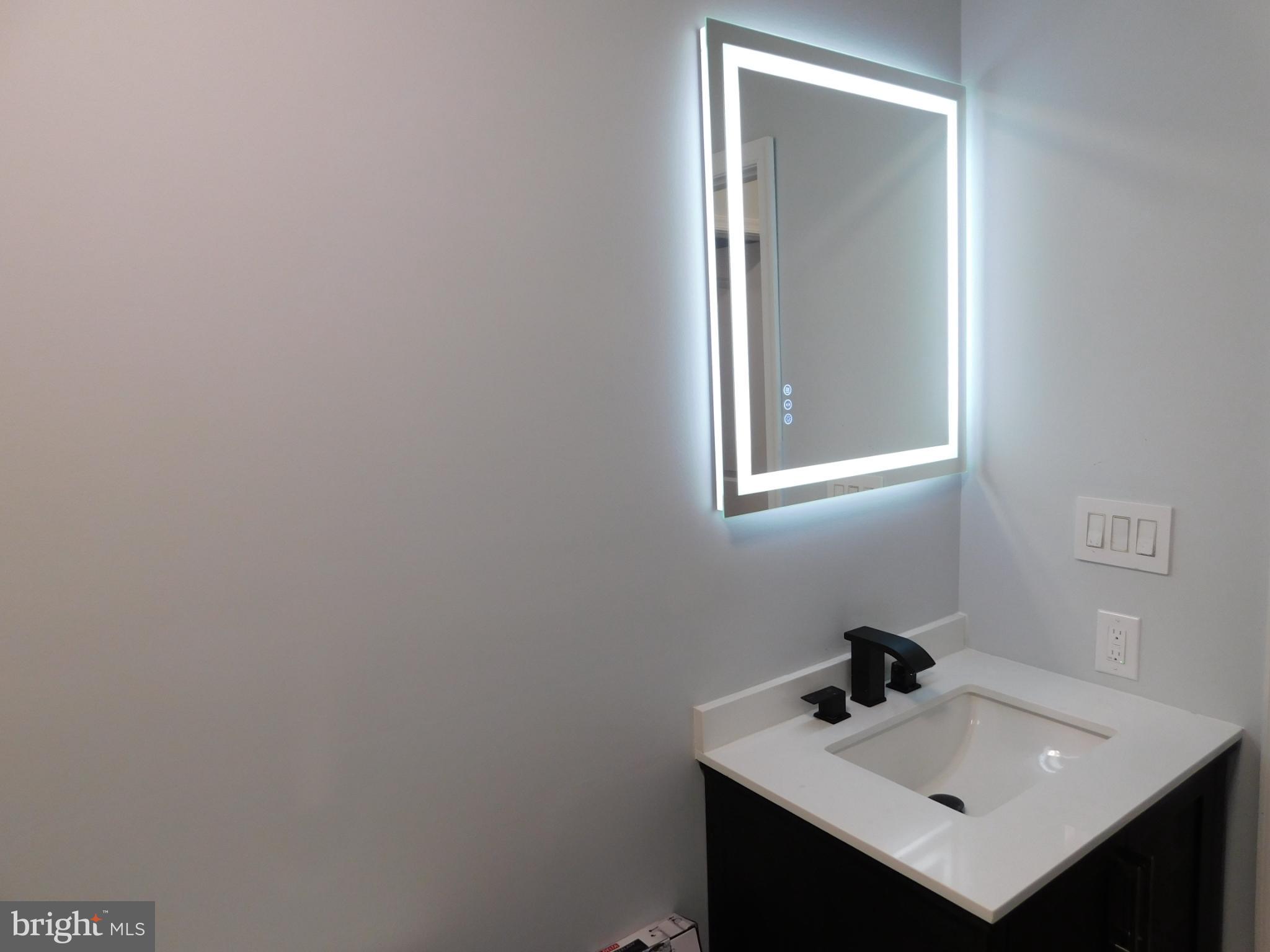 2608 Hunting Quarter Road Houston, DE 19954 - Photo 46 of 58 a bathroom with a sink and a mirror