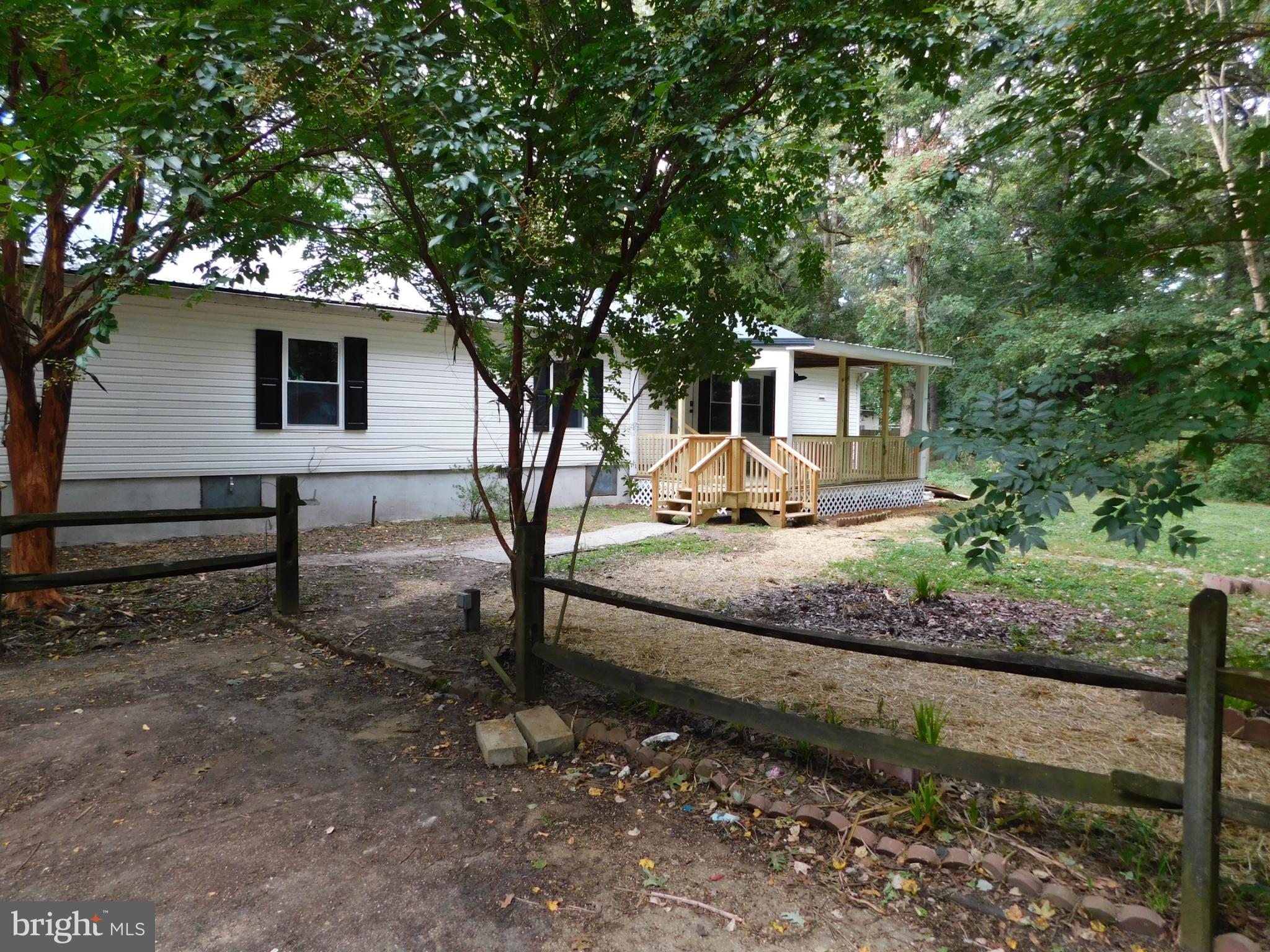 2608 Hunting Quarter Road Houston, DE 19954 - Photo 53 of 58 a white house that has a tree in front of it