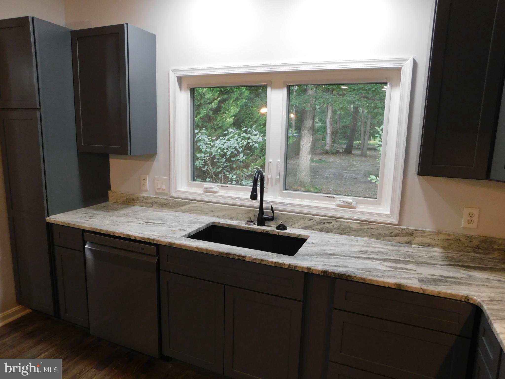2608 Hunting Quarter Road Houston, DE 19954 - Photo 6 of 58 a kitchen with granite countertop a sink and a window