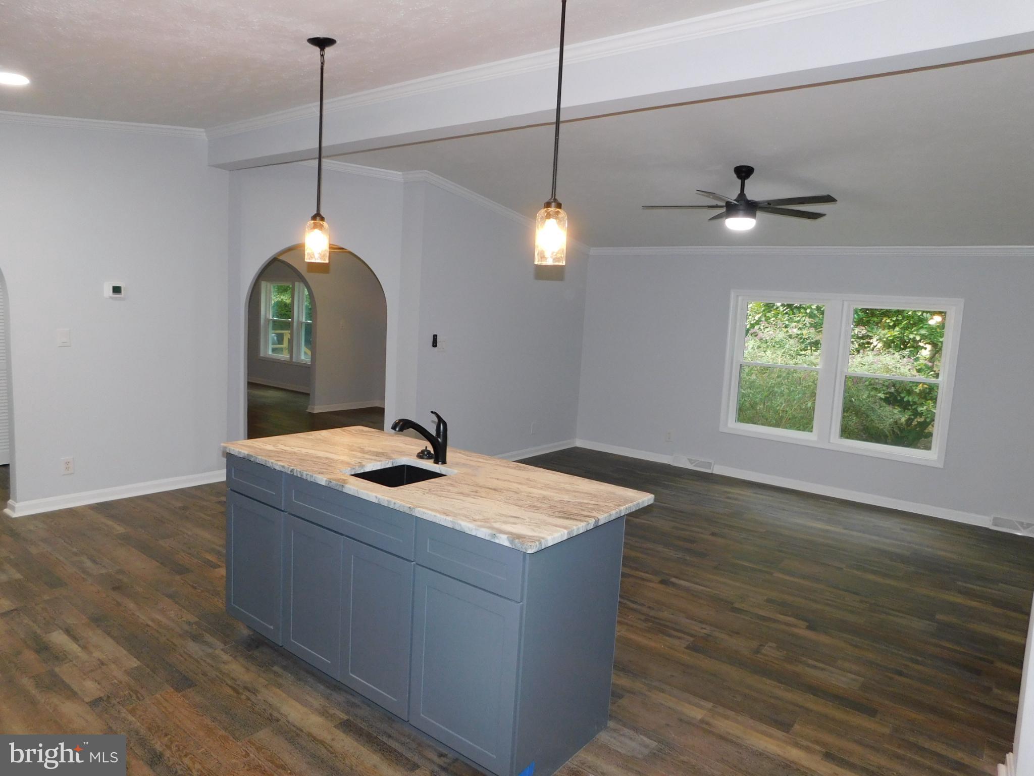 2608 Hunting Quarter Road Houston, DE 19954 - Photo 8 of 58 a kitchen with a sink stove and wooden floor