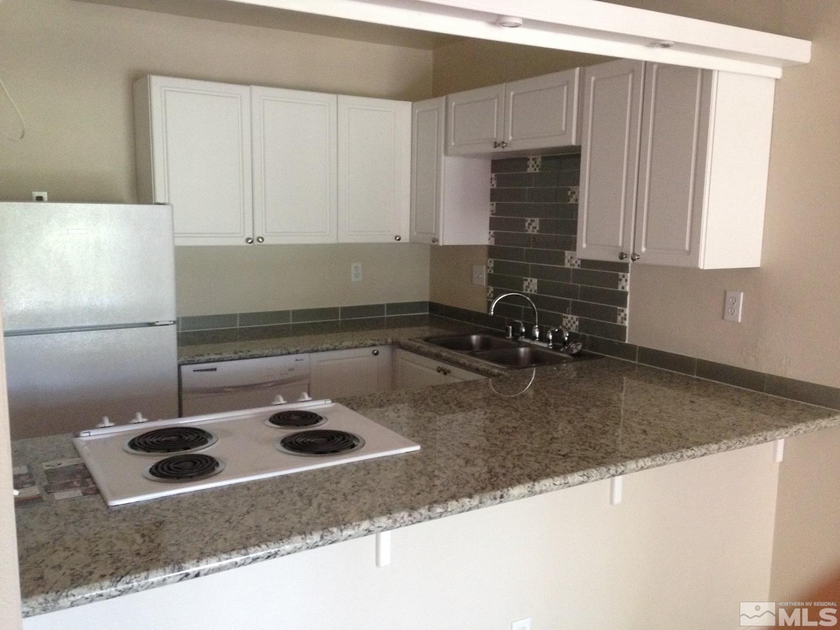 2555 Clear Acre Lane, Unit 933 Reno, NV 89512 - Photo 1 of 14 a kitchen with a sink a stove and a refrigerator
