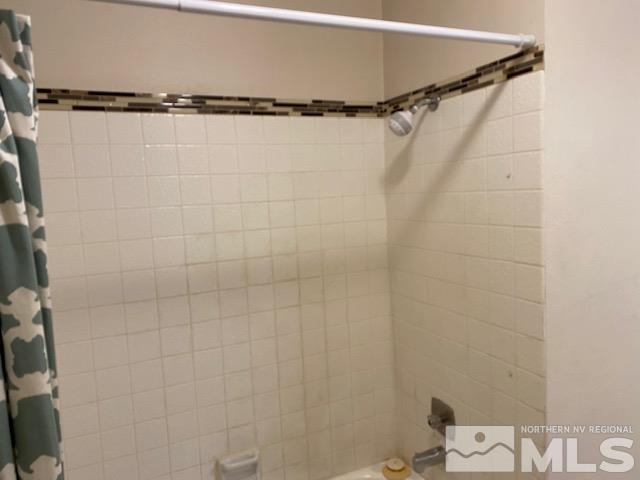 2555 Clear Acre Lane, Unit 933 Reno, NV 89512 - Photo 12 of 14 a bathroom with a shower and a bathtub