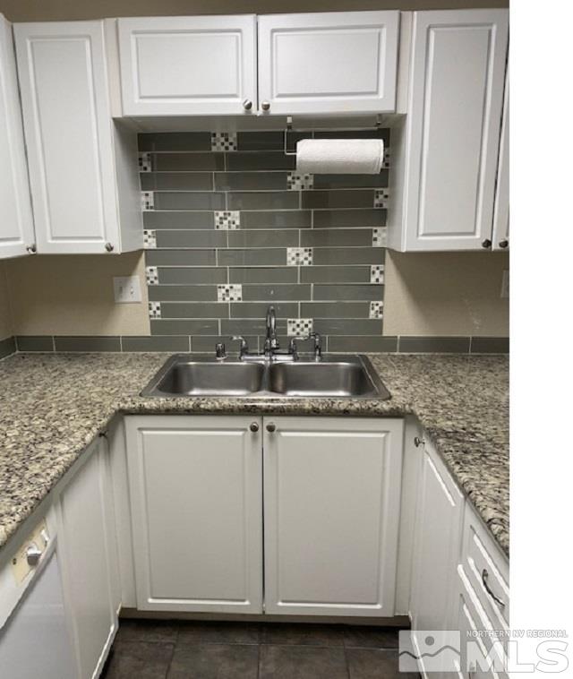 2555 Clear Acre Lane, Unit 933 Reno, NV 89512 - Photo 5 of 14 a kitchen with granite countertop a sink and cabinets
