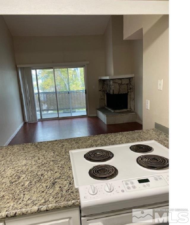 2555 Clear Acre Lane, Unit 933 Reno, NV 89512 - Photo 6 of 14 a kitchen with a stove and a wooden floor