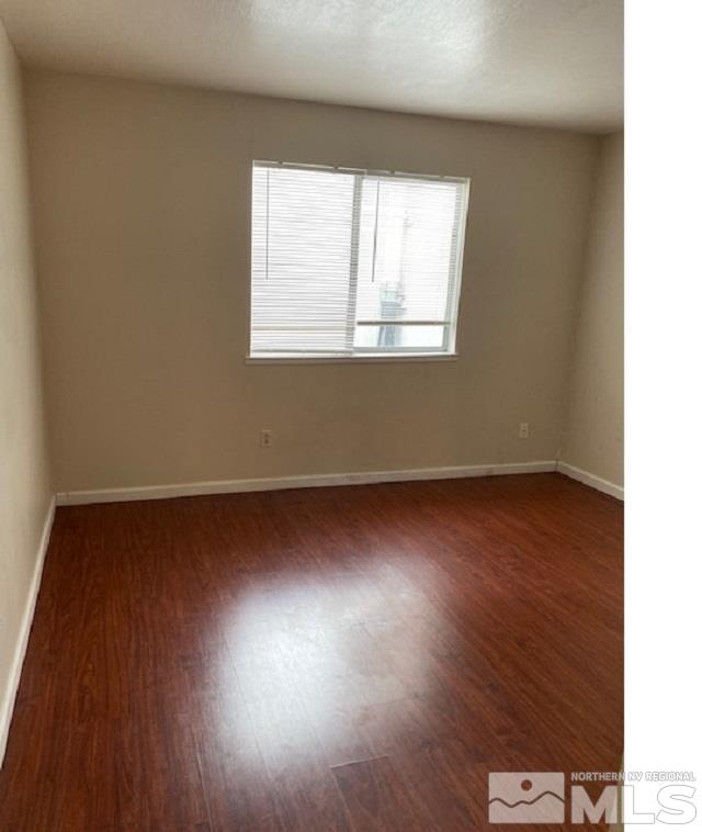 2555 Clear Acre Lane, Unit 933 Reno, NV 89512 - Photo 9 of 14 an empty room with wooden floor and windows
