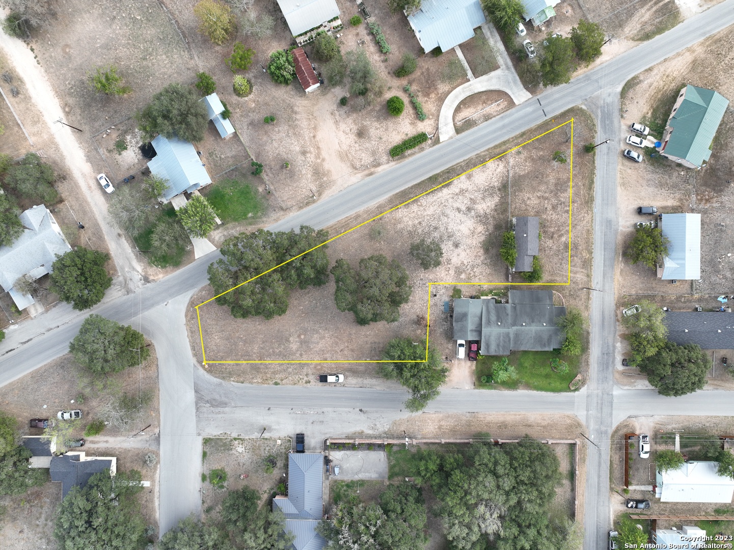 402 West Dilley Avenue Devine, TX 78016 - Photo 8 of 11 an aerial view of a house with a yard and a wooden fence