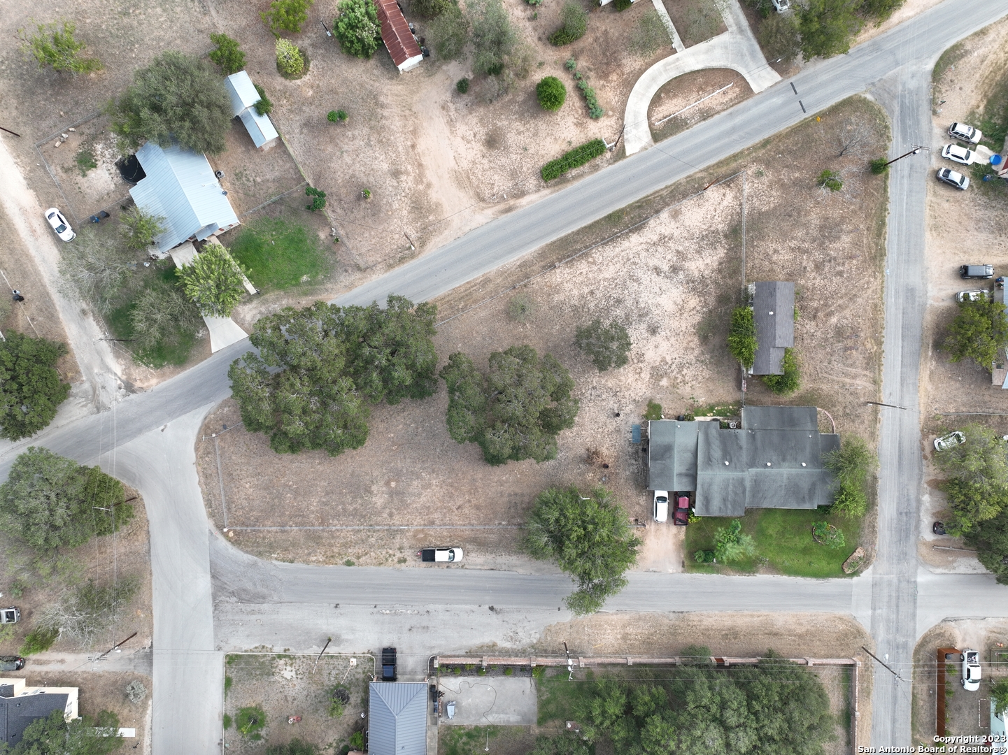 402 West Dilley Avenue Devine, TX 78016 - Photo 9 of 11 an aerial view of a house with a yard and a wooden bench