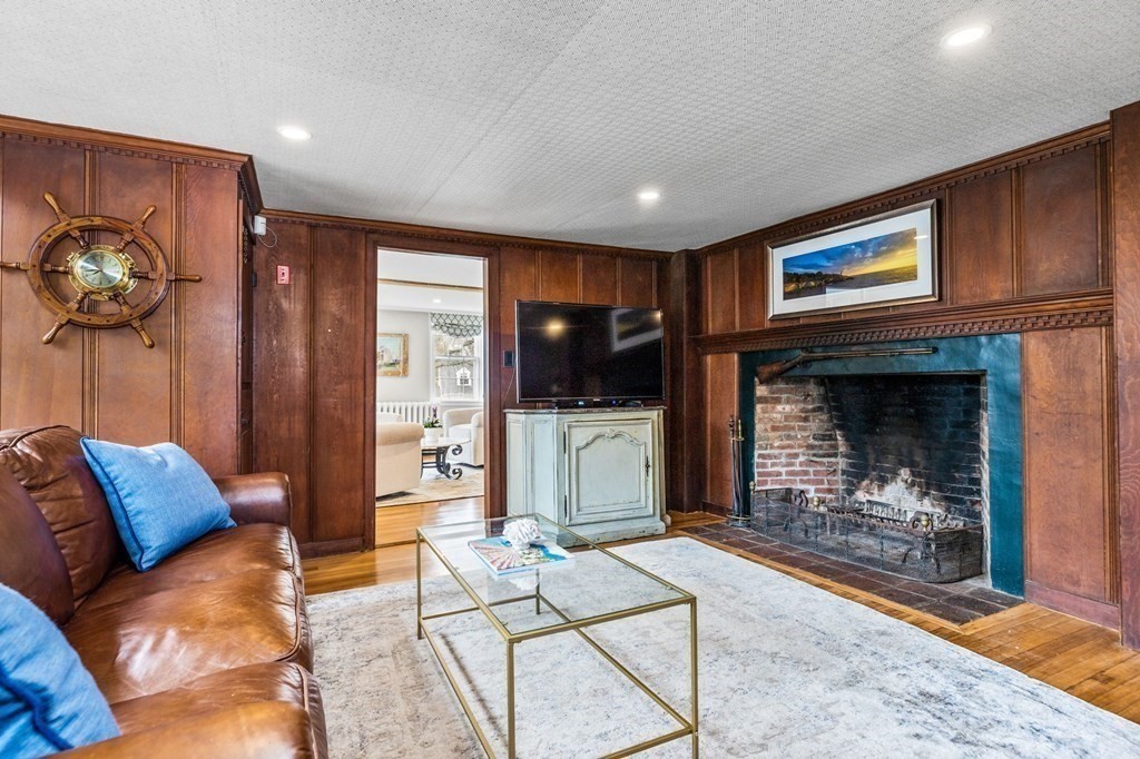 597 Main Street Hingham, MA 02043 - Photo 13 of 42 a living room with furniture a flat screen tv and a fireplace