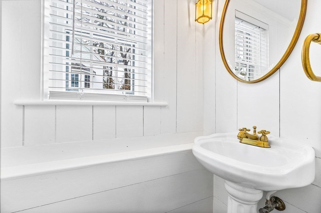 597 Main Street Hingham, MA 02043 - Photo 16 of 42 a bathroom with a sink a mirror and a toilet