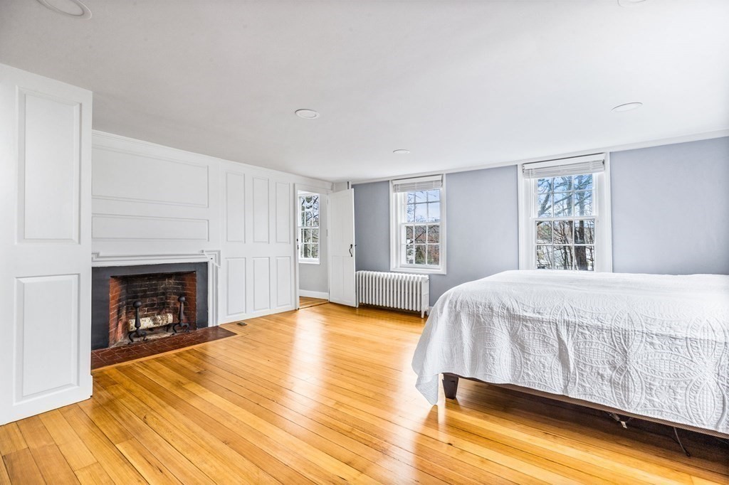 597 Main Street Hingham, MA 02043 - Photo 19 of 42 a bed room with a bed and a fireplace