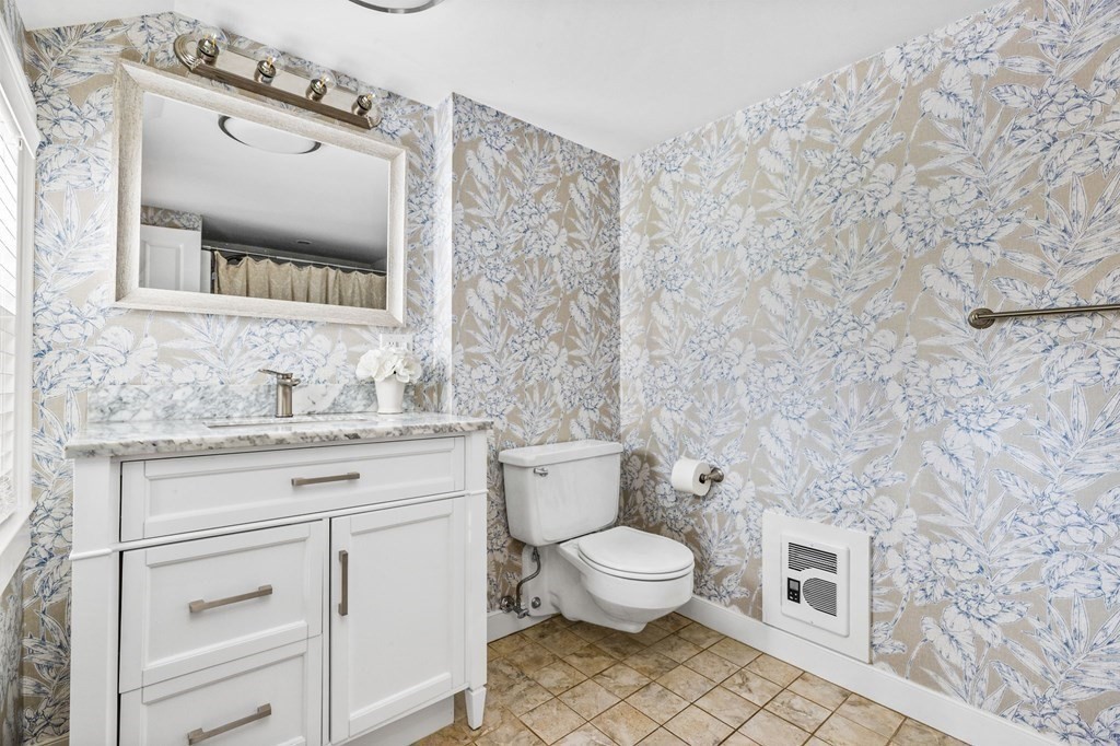 597 Main Street Hingham, MA 02043 - Photo 20 of 42 a bathroom with a granite countertop toilet sink and mirror