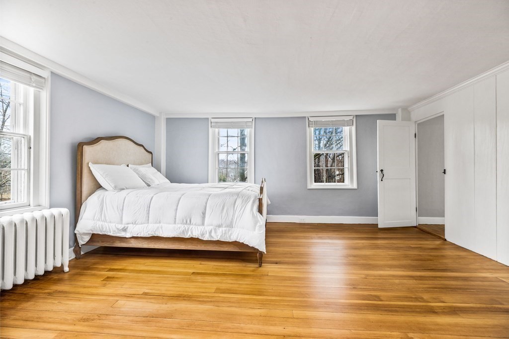 597 Main Street Hingham, MA 02043 - Photo 22 of 42 a bedroom with a bed and wooden floor