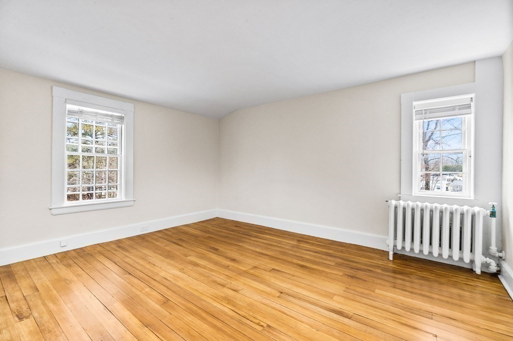 597 Main Street Hingham, MA 02043 - Photo 24 of 42 a view of an empty room with wooden floor and a window