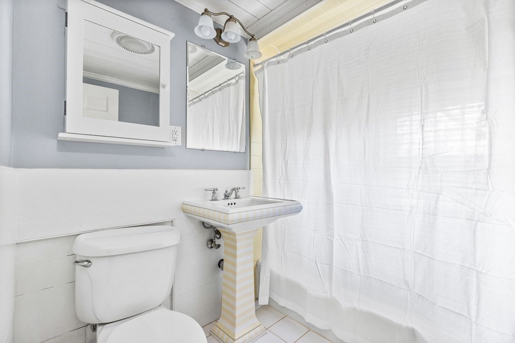 597 Main Street Hingham, MA 02043 - Photo 27 of 42 a bathroom with a sink a toilet and shower