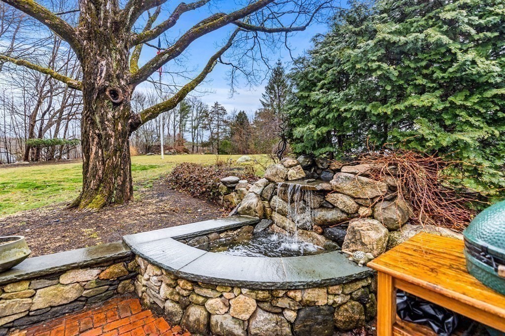 597 Main Street Hingham, MA 02043 - Photo 38 of 42 a view of a backyard with a fountain