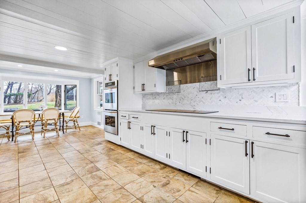 597 Main Street Hingham, MA 02043 - Photo 7 of 42 a kitchen with granite countertop a stove a sink and a refrigerator
