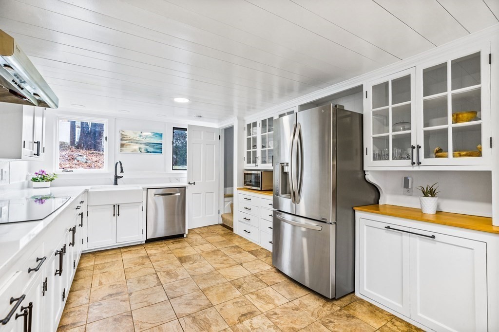 597 Main Street Hingham, MA 02043 - Photo 8 of 42 a kitchen with a refrigerator sink and cabinets