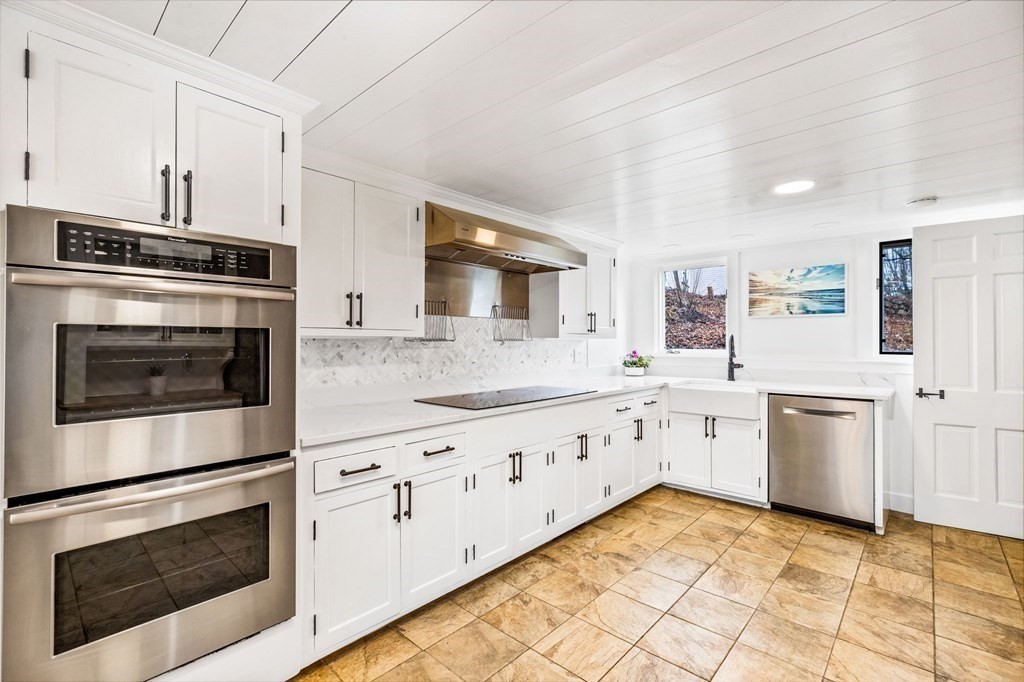 597 Main Street Hingham, MA 02043 - Photo 9 of 42 a kitchen with granite countertop white cabinets stainless steel appliances and sink