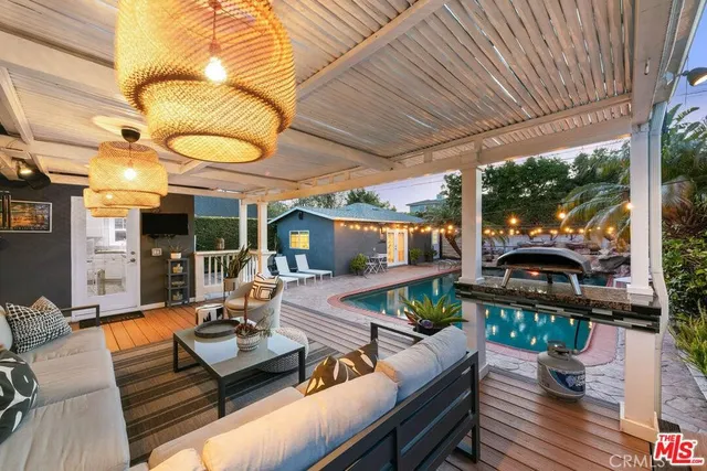 a living room with patio furniture and a fireplace