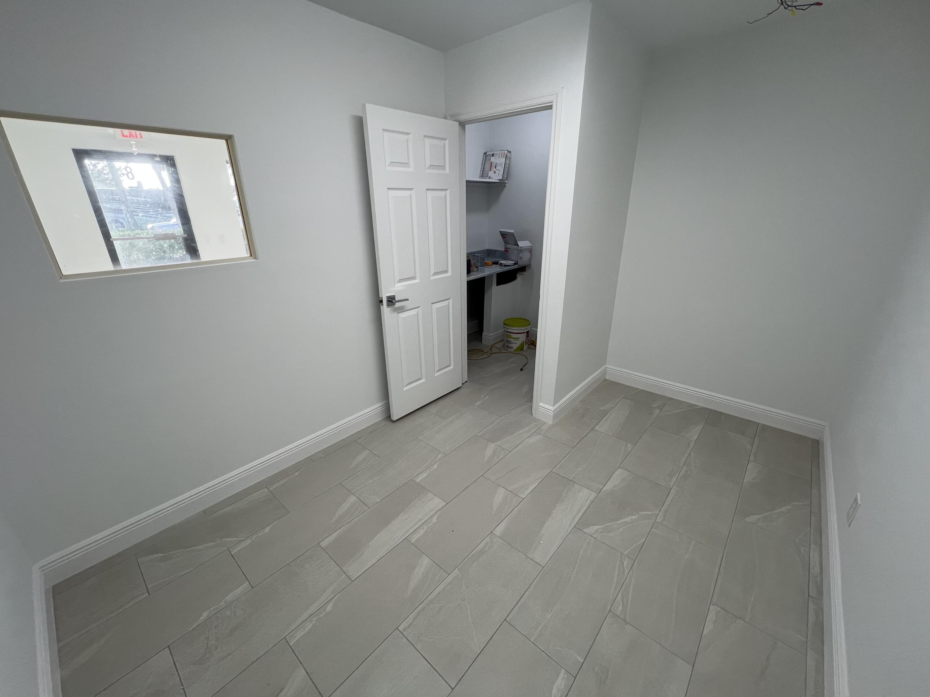500 Commerce Way West, Unit 8 Jupiter, FL 33458 - Photo 2 of 9 a view of empty room with window and refrigerator