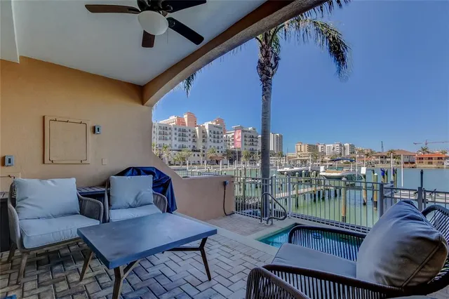 a view of a balcony with wooden floor and outdoor seating