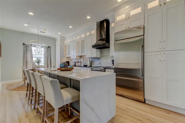 a view of a dining room with furniture and chandelier