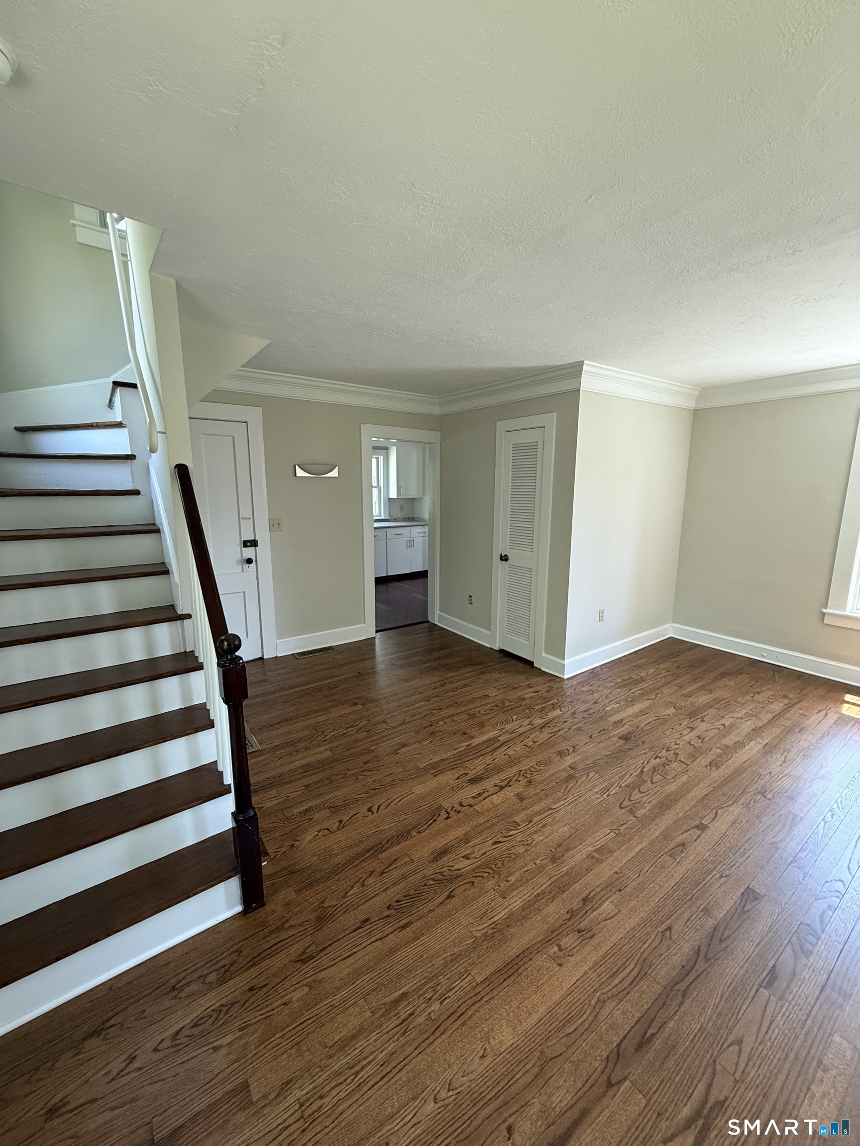312 Ferry Road Old Lyme, CT 06371 - Photo 10 of 16 a view of a room with wooden floor and stairs