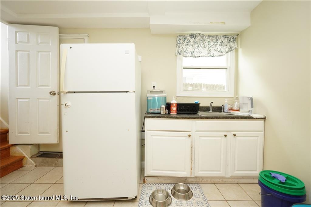 301 Lightner Avenue Staten Island, NY 10314 - Photo 15 of 17 a white refrigerator freezer sitting inside of a kitchen