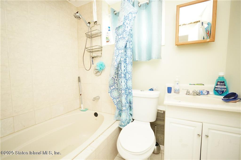 301 Lightner Avenue Staten Island, NY 10314 - Photo 17 of 17 a bathroom with a sink a toilet and shower