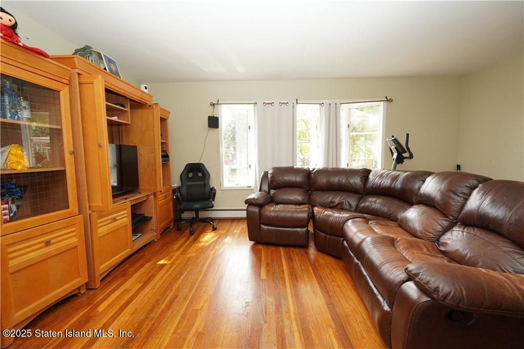 301 Lightner Avenue Staten Island, NY 10314 - Photo 3 of 17 a living room with furniture and a wooden floor