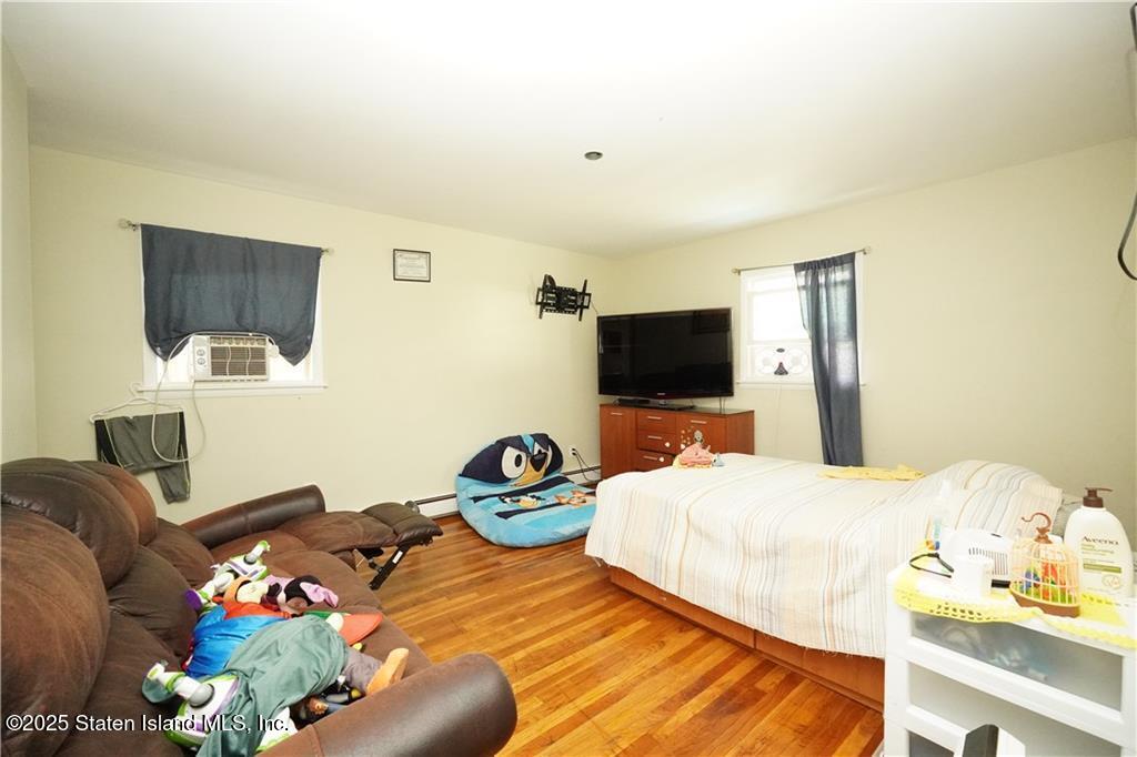 301 Lightner Avenue Staten Island, NY 10314 - Photo 7 of 17 a bedroom with a bed and flat screen tv