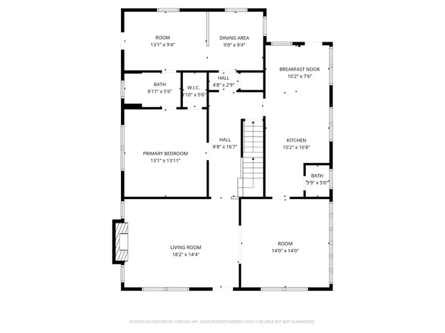 a view of empty room with wooden floor and fireplace