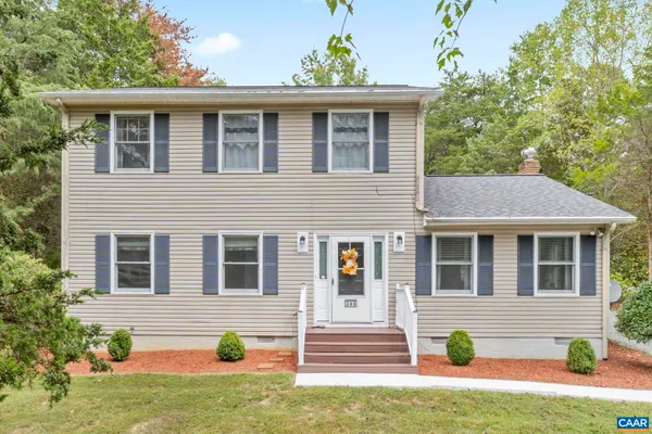 a front view of a house with a yard and potted plants