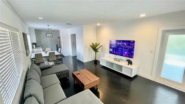 a living room with furniture and wooden floor