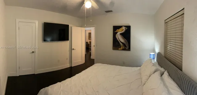 a bedroom with a bed and a flat screen tv